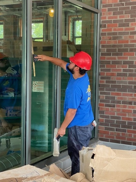 Nice and Clean Solutions worker cleans windows