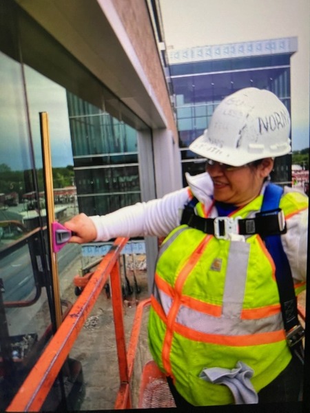 Nice and Clean Solutions female worker cleans window